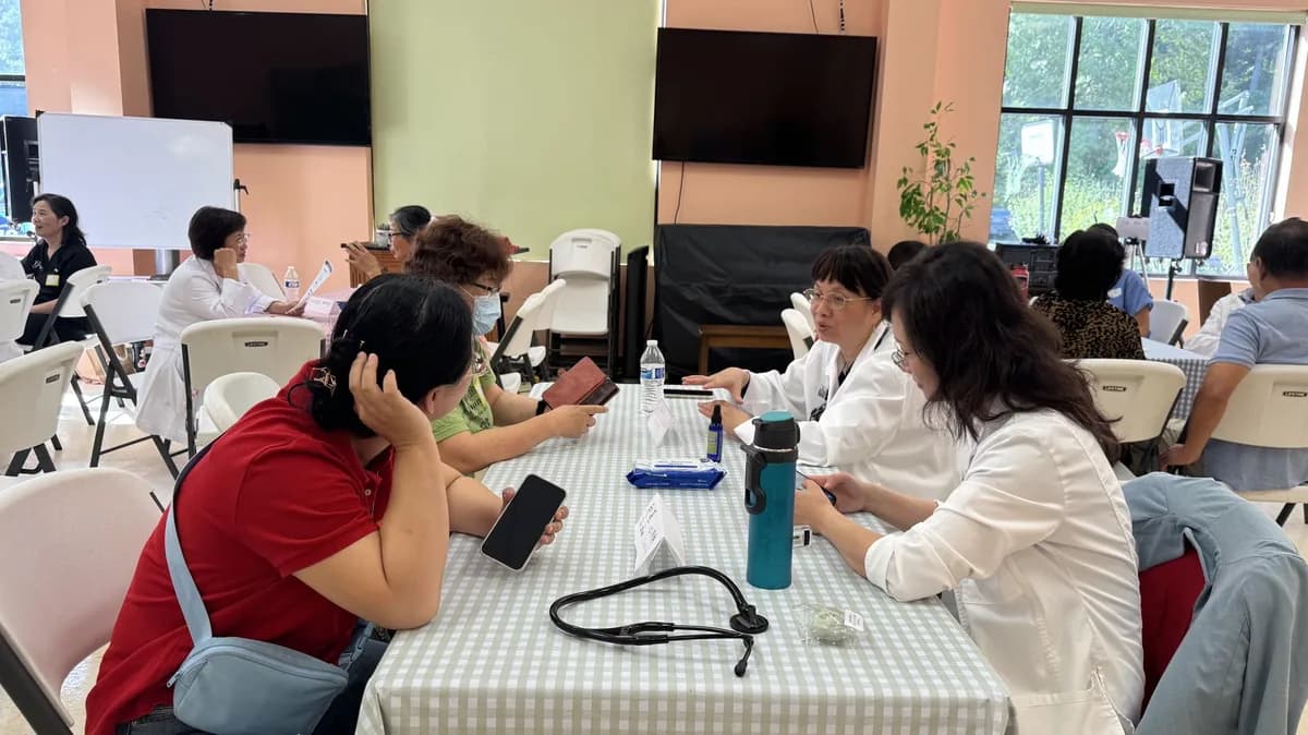 A healthcare professional consulting with a community member at a CCHPA community health event